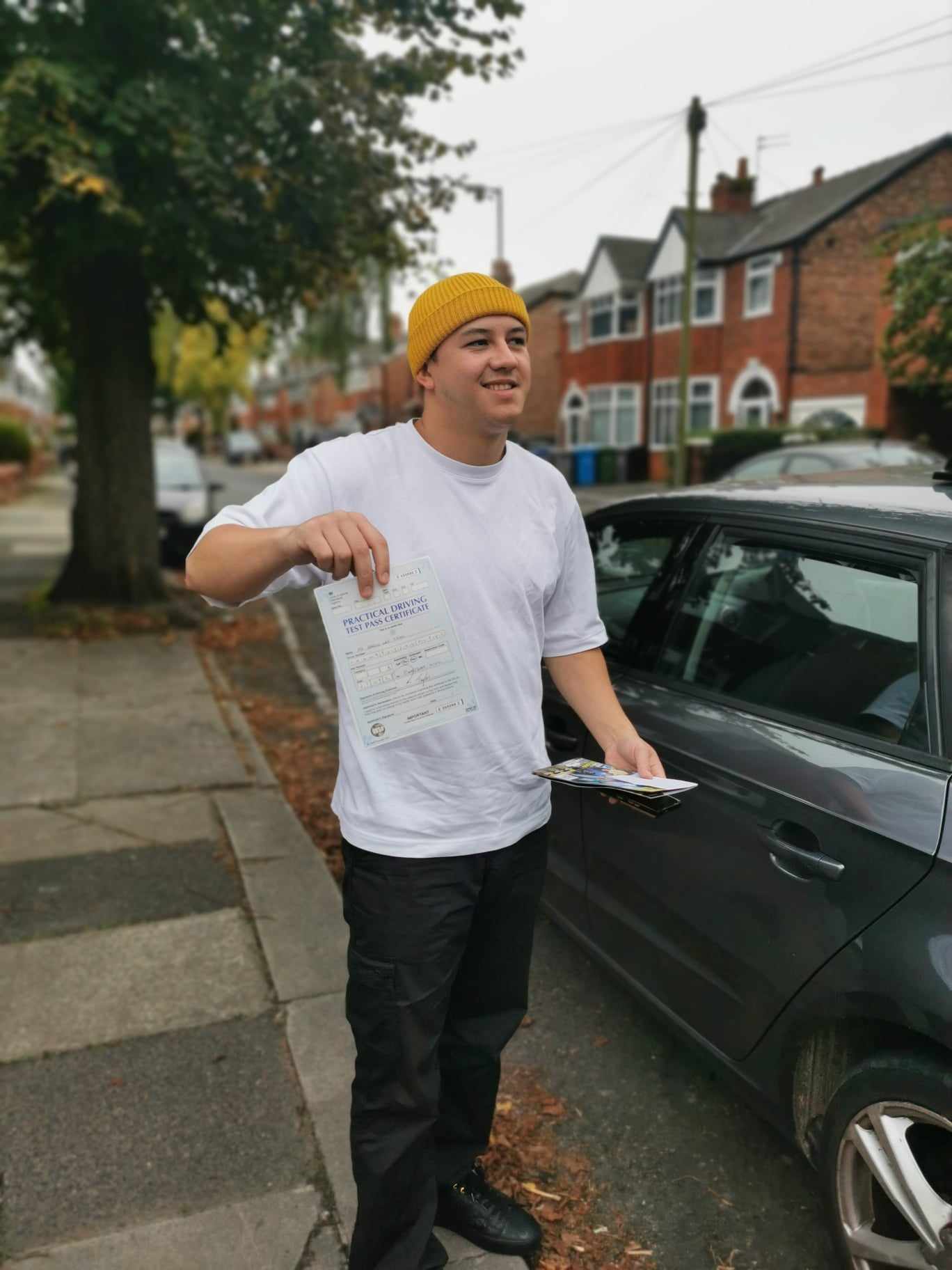 Successful driving test candidate celebrating passing with Drive Fleet instructor