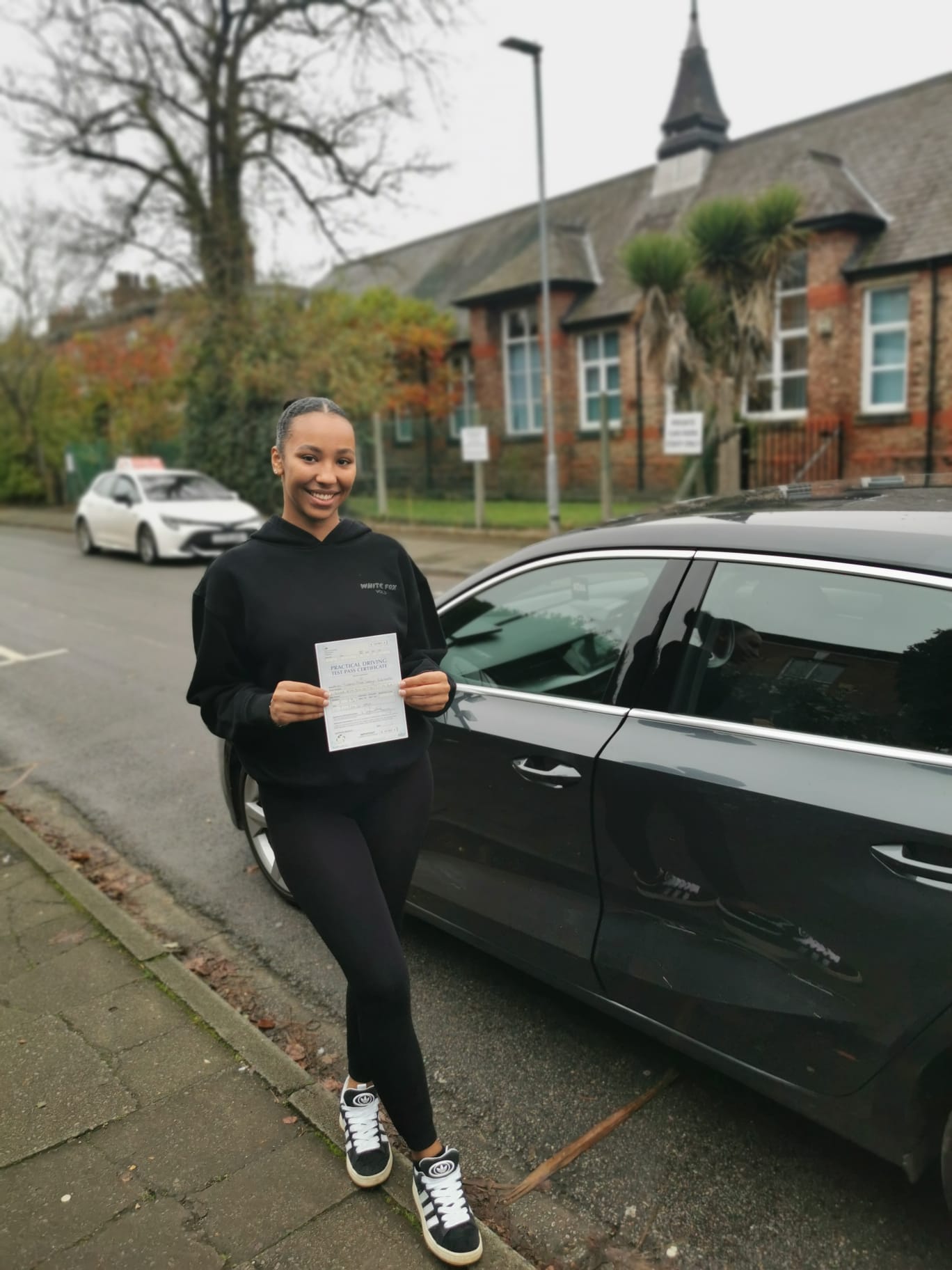 Successful driving test pass - Happy student with instructor after passing driving test in Manchester